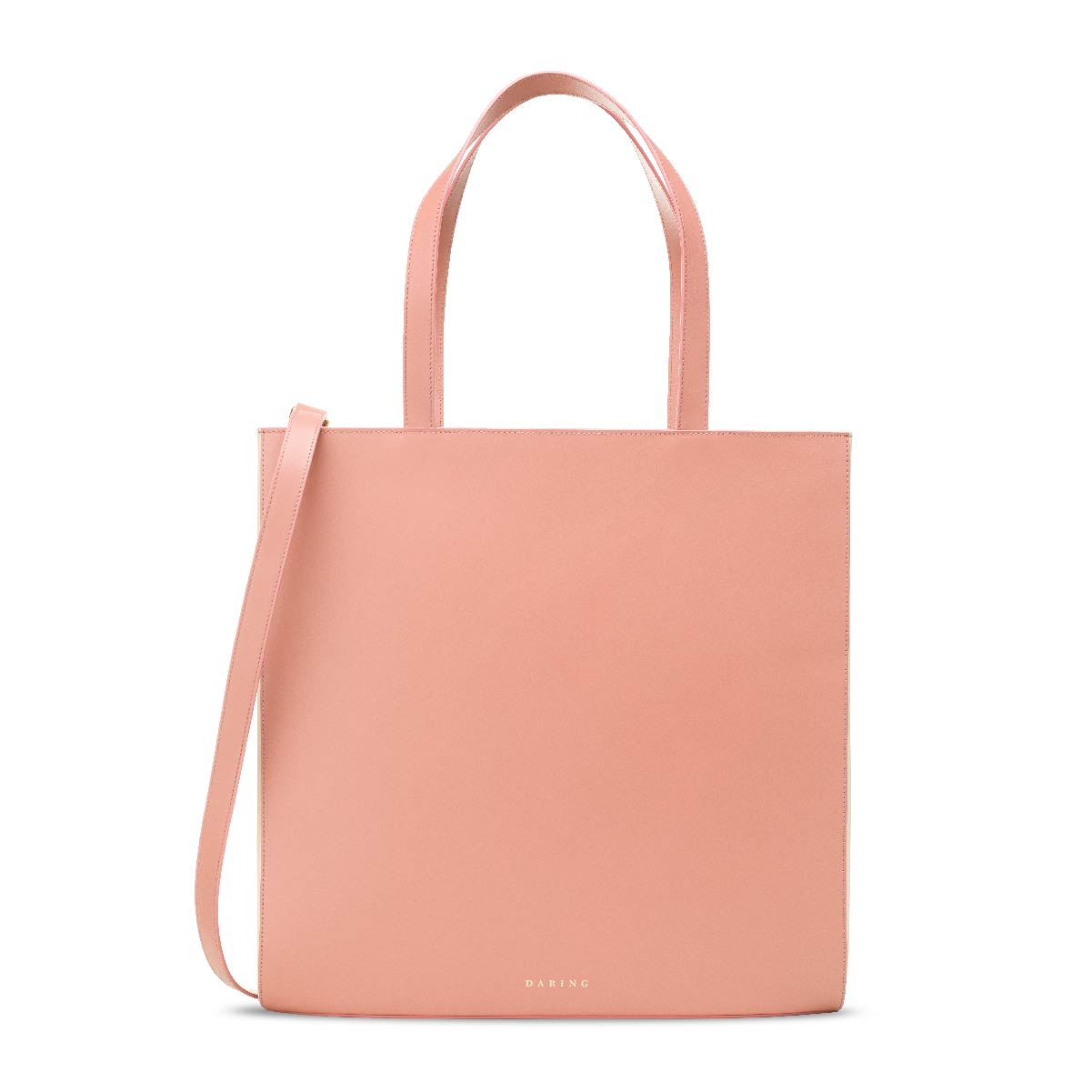 The Tote in Pink + Cream, with removable strap and top handles, front view.